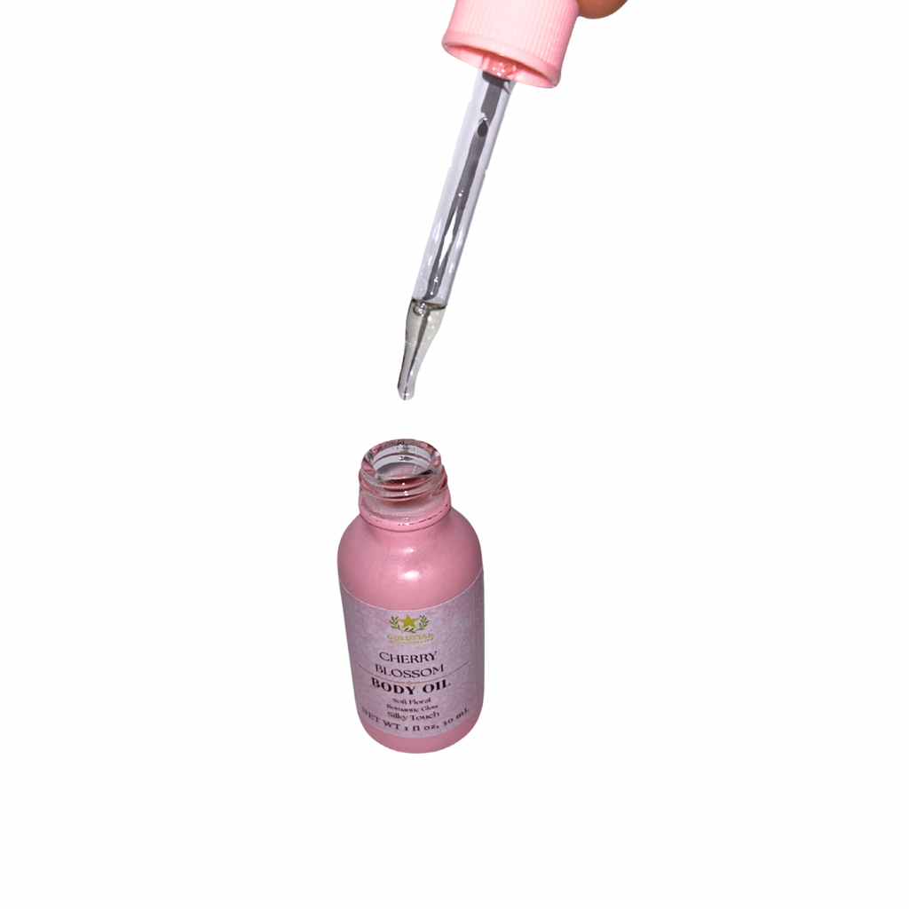 Pink bottle of body oil with a dropper on a white background